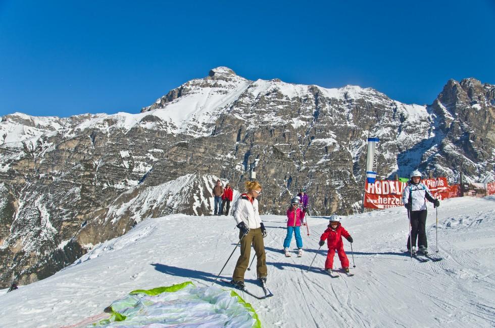 INNSBRUCK, AUSTRIA - MARCH 14: Families enjoy skiing at Alp mountain, Innsbruck, Austria on March 14, 2012. Innsbruck belongs to one of the best winter sports regions of the Alps.